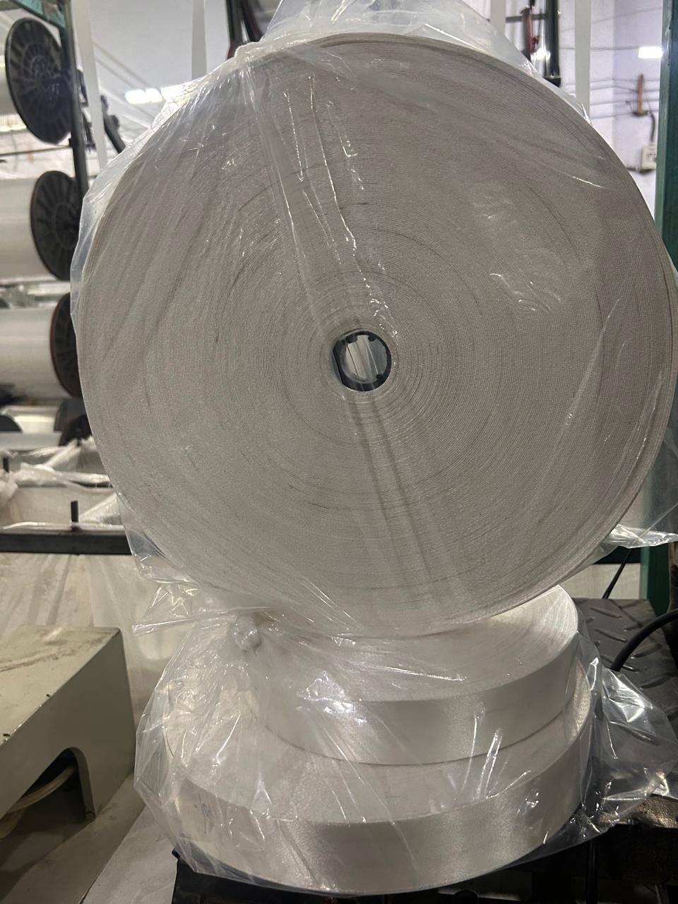 Large roll of 38 mm white belt webbing in the factory